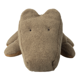 A soft, plush crocodile toy with a simple, cute design on a white background. It features a textured, light brown fabric and tiny embroidered eyes.
