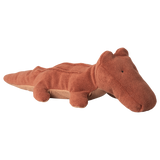 A brown plush crocodile toy lies on a white background. The toy has a soft, textured surface with a whimsical, friendly expression, conveying a playful mood.