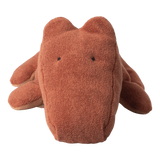 A rust-colored, textured stuffed toy resembling a simplistic animal, likely a bear, on a white background. It has a soft, cuddly appearance.