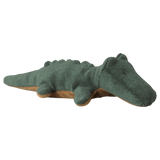 A plush green crocodile toy on a white background. It has textured fabric, a smiling expression, and soft, rounded features, conveying a playful tone.