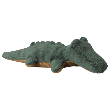 A plush green crocodile toy on a white background. It has textured fabric, a smiling expression, and soft, rounded features, conveying a playful tone.