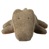 A plush toy crocodile made of textured fabric is centered on a white background. It looks soft and cuddly with a simple, cute expression.