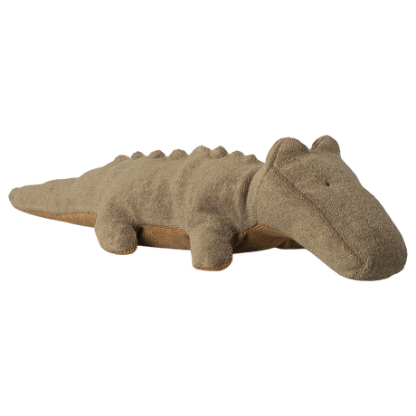 A soft, brown stuffed animal shaped like a crocodile lies against a white background. It has small eyes and a friendly, relaxed appearance.