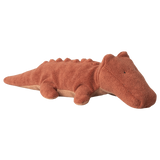 A soft, brown plush crocodile toy with a textured surface and small limbs, lying on a white background. The toy conveys a calm, friendly demeanor.