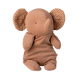 A soft, brown elephant plush toy with polka-dotted ears sits upright. Its simple features and neutral colors convey a cozy, comforting feel.