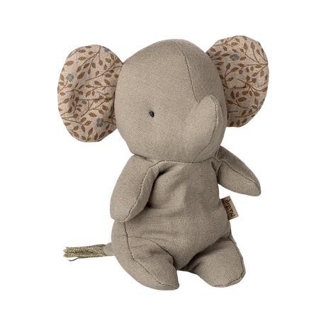 A soft, beige elephant plush with patterned ears featuring leaf designs. The toy has a simple, minimalist look, conveying a calm, cozy vibe.