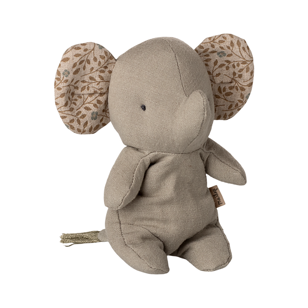 A soft, beige elephant plush with patterned ears featuring leaf designs. The toy has a simple, minimalist look, conveying a calm, cozy vibe.