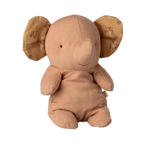 A soft, tan elephant stuffed toy with patterned, floppy ears. Its simple, smiling face and plush body create a warm and comforting appearance.