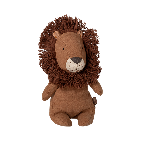Soft, brown lion plush toy with a fluffy mane, button eyes, and a stitched nose, sitting upright. Its expression is calm and friendly.