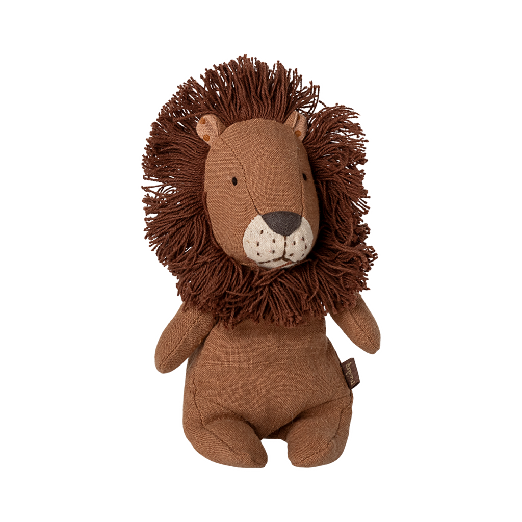 Soft, brown lion plush toy with a fluffy mane, button eyes, and a stitched nose, sitting upright. Its expression is calm and friendly.