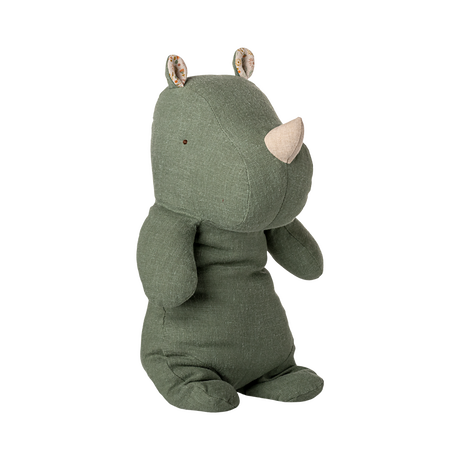 Stuffed toy rhino with a soft, green fabric body, beige horn, and floral-patterned ears. The plush exudes a calm and cozy vibe.