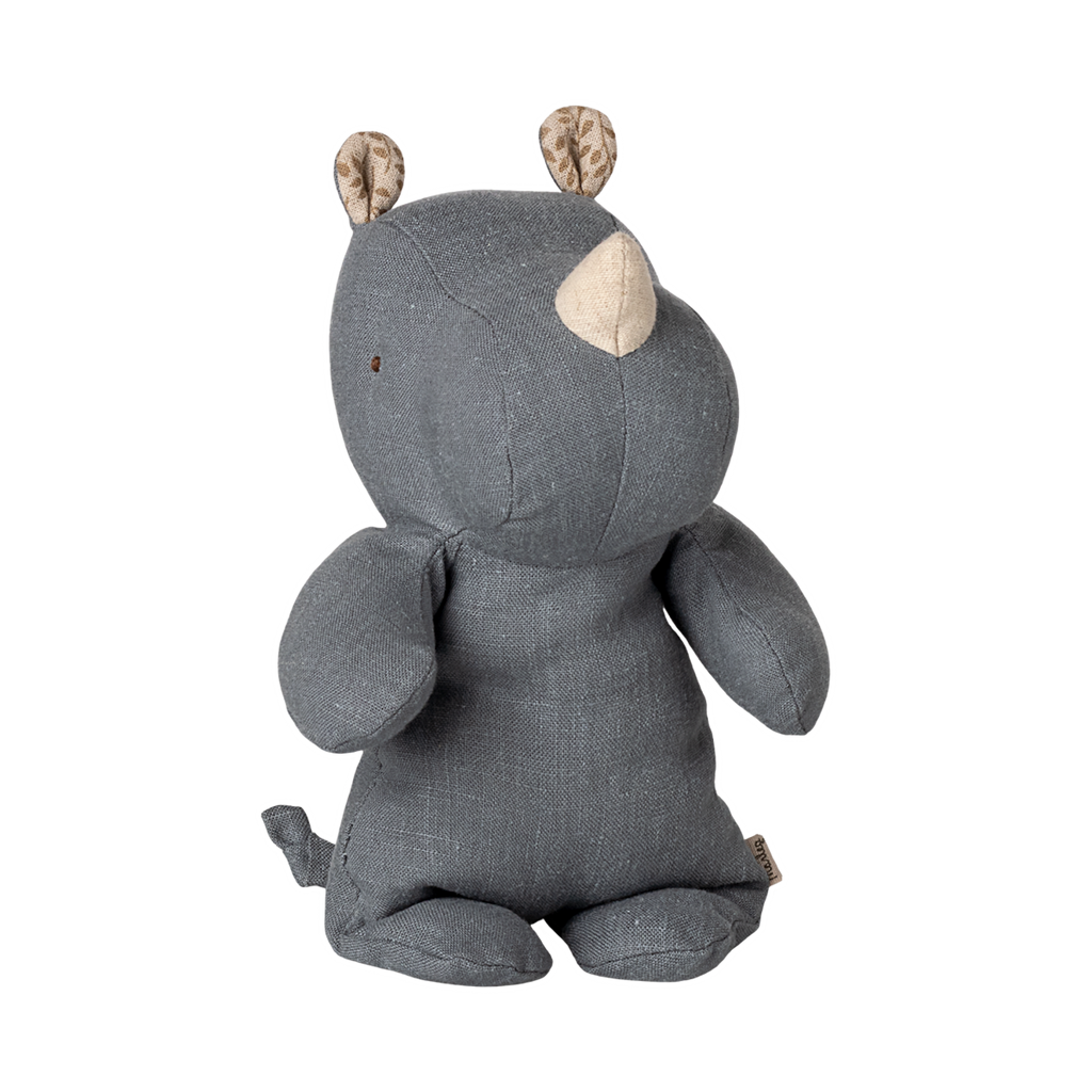 A cute gray fabric rhino plush toy sits upright with leaf-patterned ears and a beige snout, conveying a sense of warmth and comfort.