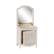 A miniature white vanity with a mirror, featuring a gold faucet and taps. The cabinet door is slightly ajar, conveying a quaint and elegant feel.