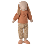 Maileg size 3 classic bunny doll wearing a coral knitted sweater and floral pants.