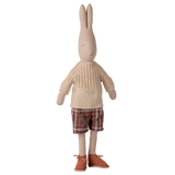 Maileg size 4 bunny doll wearing an off-white knitted sweater, plaid shorts, and brown shoes.