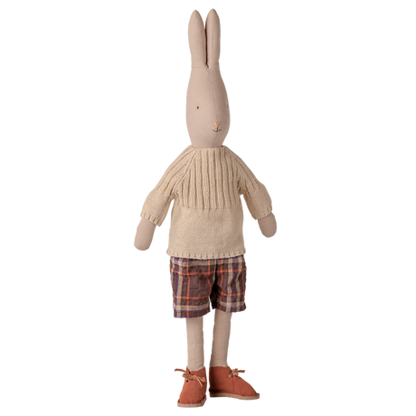 Maileg size 4 bunny doll wearing an off-white knitted sweater, plaid shorts, and brown shoes.
