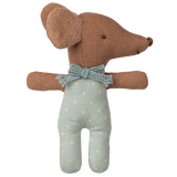 A soft, brown toy dog with floppy ears and a textured surface, wearing a blue polka dot outfit and bow tie, set against a white background.
