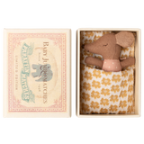 Toy mouse in a matchbox bed with a polka dot shirt and patterned blanket. Box lid reads "Baby Jumbo Matches" with an elephant illustration.