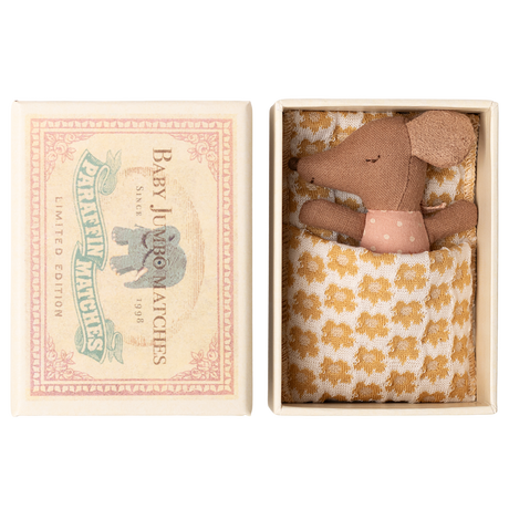Toy mouse in a matchbox bed with a polka dot shirt and patterned blanket. Box lid reads "Baby Jumbo Matches" with an elephant illustration.