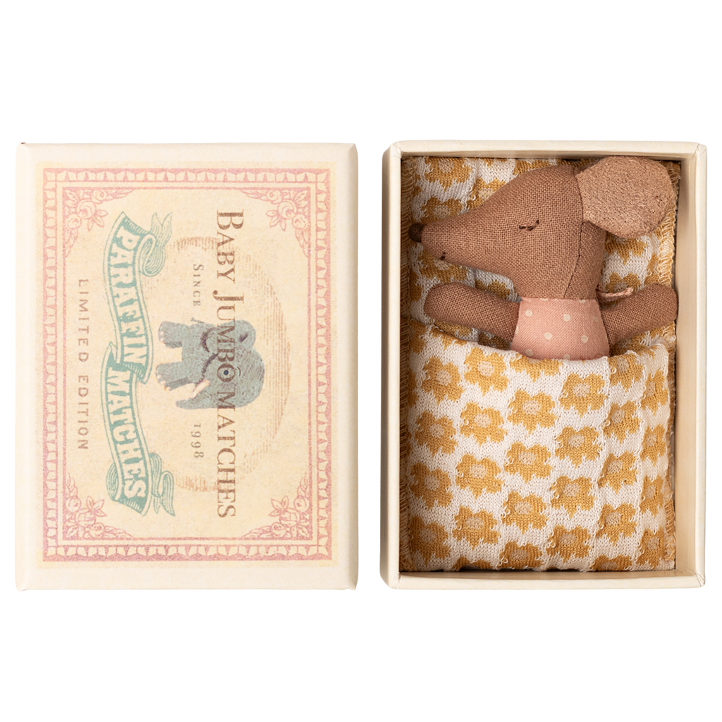 Toy mouse in a matchbox bed with a polka dot shirt and patterned blanket. Box lid reads "Baby Jumbo Matches" with an elephant illustration.