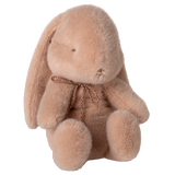 Maileg small bunny plush in powder pink with a rose gold bow and floppy ears on a white background.