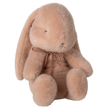 Maileg small bunny plush in powder pink with a rose gold bow and floppy ears on a white background.