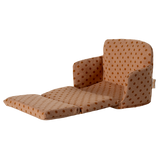 Miniature beige sofa with brown polka dots, featuring plush cushions and compact armrests. The playful design suggests a cozy, dollhouse ambiance.