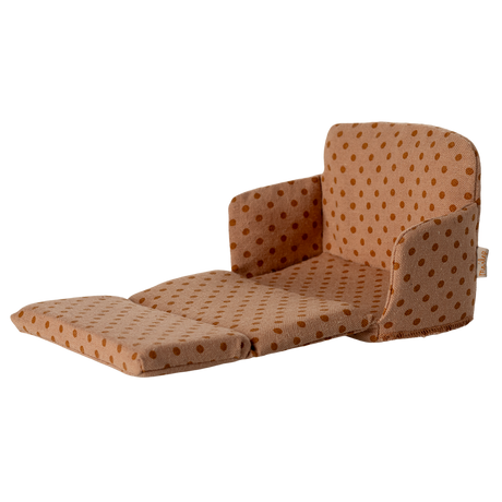 Miniature beige sofa with brown polka dots, featuring plush cushions and compact armrests. The playful design suggests a cozy, dollhouse ambiance.