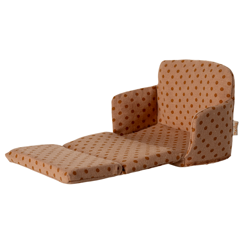 Miniature beige sofa with brown polka dots, featuring plush cushions and compact armrests. The playful design suggests a cozy, dollhouse ambiance.