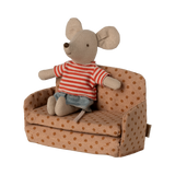 Miniature beige sofa with brown polka dots, featuring plush cushions and compact armrests. The playful design suggests a cozy, dollhouse ambiance.