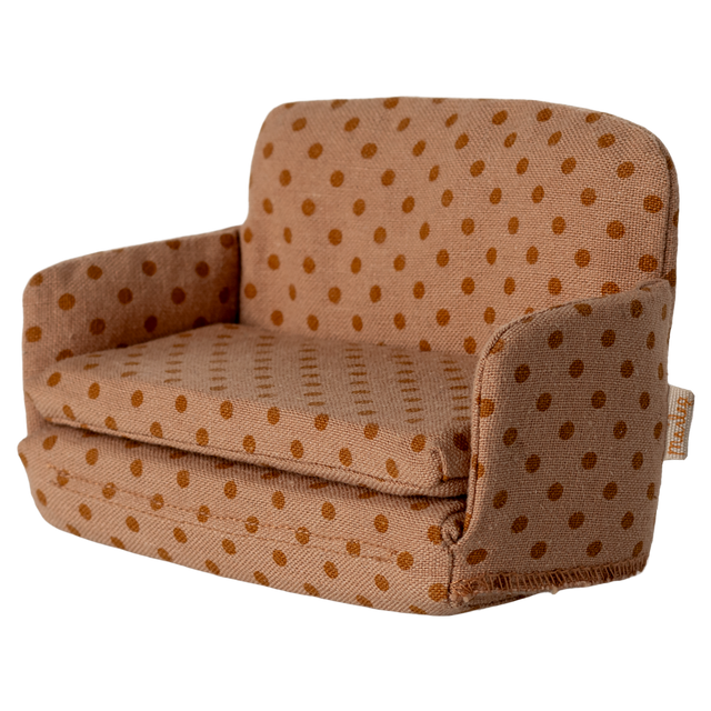 Miniature beige sofa with brown polka dots, featuring plush cushions and compact armrests. The playful design suggests a cozy, dollhouse ambiance.