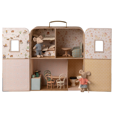 Dollhouse shaped like a suitcase, featuring mouse figurines. It has a cozy bedroom, a living area, and a kitchen, evoking a playful and quaint charm.