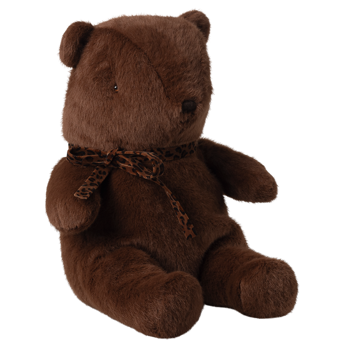 A soft, brown teddy bear with a leopard print scarf sits upright against a white background. The bear exudes a cozy and comforting vibe.