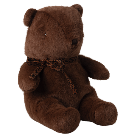 A soft, brown teddy bear with a leopard print scarf sits upright against a white background. The bear exudes a cozy and comforting vibe.