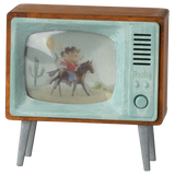 Vintage TV model with wooden frame and aqua trim displaying a cowboy on a horse in a desert scene with a cactus, evoking nostalgia.
