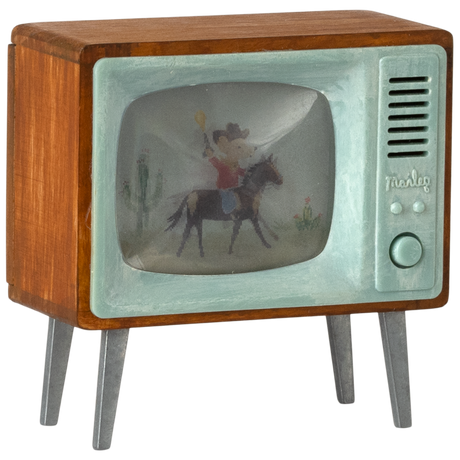 Retro-style model television with a wood frame, pale green front, and metal legs. Screen shows a cowboy on a horse near cacti, evoking vintage charm.