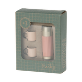A stylish pink thermos with a gold lid and two matching pastel cups in white background.