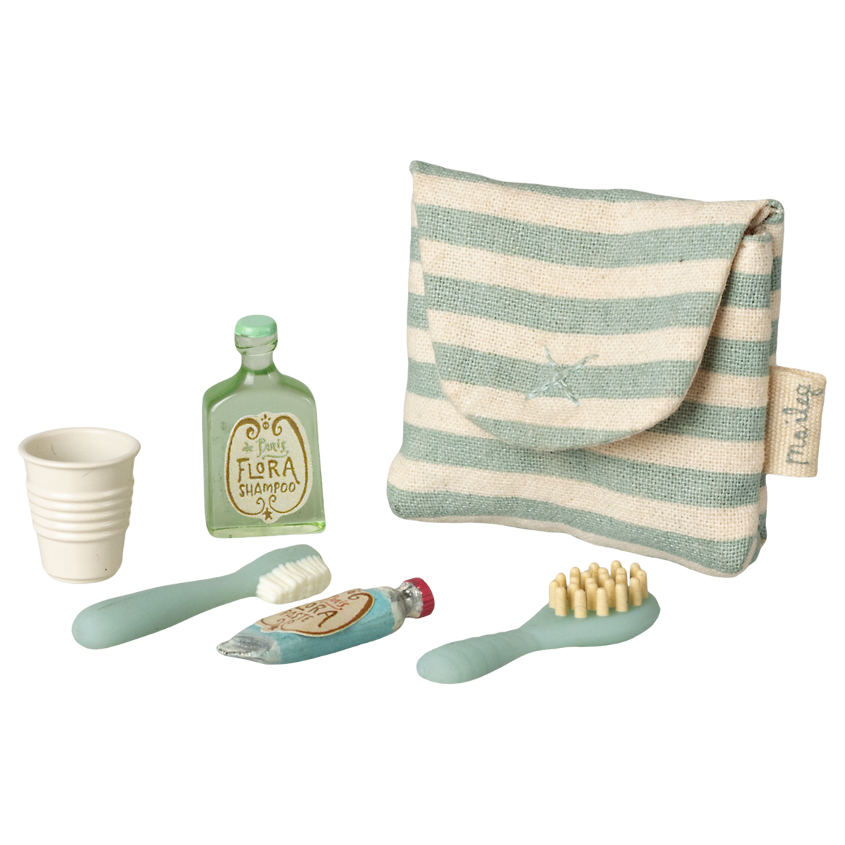 A striped pouch with tiny toiletries: a green shampoo bottle, a toothbrush, toothpaste, a hairbrush, and a collapsible cup on a white background.
