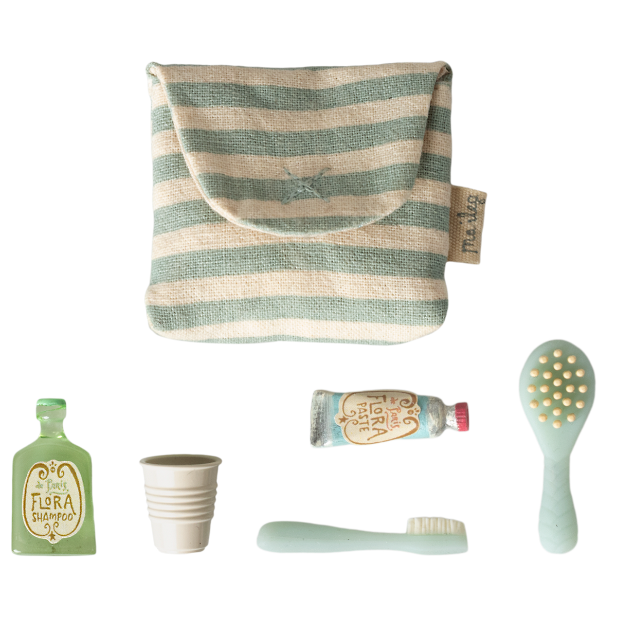 A striped pouch alongside a green shampoo bottle, a white cup, a blue toothpaste tube, a toothbrush, and a hairbrush, arranged on a white background.