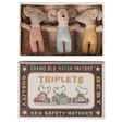 Three plush toy mice wearing red, blue, and yellow outfits lie in a decorative box labeled "TRIPLETS" with vintage-style graphics of mice driving cars.