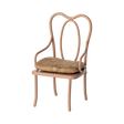 Elegant miniature antique chair with a beige floral-patterned cushion. The chair has curved metal legs and intricate, looping back design, conveying vintage charm.