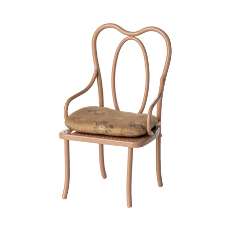 Elegant miniature antique chair with a beige floral-patterned cushion. The chair has curved metal legs and intricate, looping back design, conveying vintage charm.