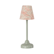 Elegant miniature table lamp with a smooth, green base and a fabric shade adorned with delicate red floral patterns, conveying a classic, cozy ambiance.