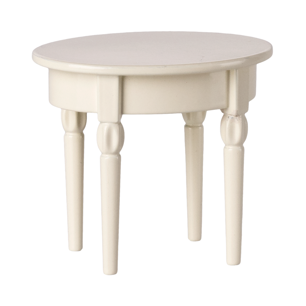A miniature, round, cream-colored table with four turned wooden legs. The table has a smooth surface and a classic, minimalist design.