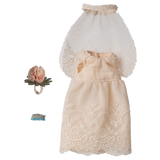 Delicate pink lace doll dress with a flared skirt, flowery headpiece, and light blue garter, set against a white background.