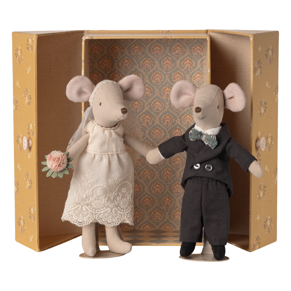 Two stuffed mice dressed as a bride and groom stand inside an ornate, open box. The bride holds a bouquet, and the groom wears a bow tie.