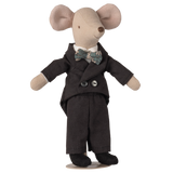 Stuffed toy mouse dressed in a black suit and floral bow tie, standing upright against a white background. The mouse exudes a cute, formal charm.