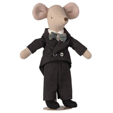 Stuffed toy mouse dressed in a black suit and floral bow tie, standing upright against a white background. The mouse exudes a cute, formal charm.