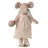 A cute fabric mouse doll wearing a delicate lace wedding dress and veil, holding a small bouquet of pink flowers, set against a white background.
