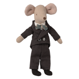 A plush mouse doll wears a dark suit with gray buttons and a patterned bow tie, exuding a charming, sophisticated look against a white background.